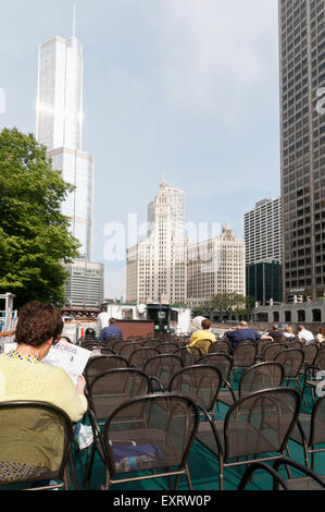 Tourists aboard a Chicago Architecture Foundation river cruise with the Trump Tower and Wrigley Building in background. Stock Photo