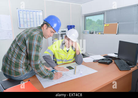 Two construction workers discussing plans Stock Photo