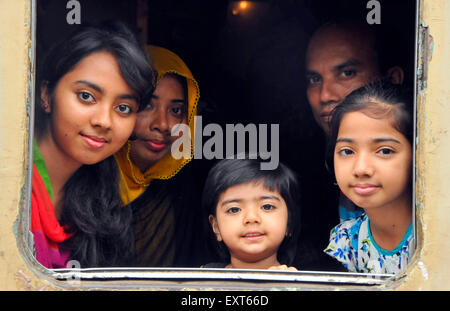 Dhaka, Bangladesh. 16th July, 2015. Passengers sit in a train leaving for their hometowns for the upcoming Eid al-Fitr festival in Dhaka, Bangladesh, July 16, 2015. The Muslim majority Bangladesh will celebrate the Eid-ul-Fitr, one of the biggest religious festivals celebrated after Ramadan, on or around July 18 or 19 based on sighting of the new moon. Credit:  Shariful Islam/Xinhua/Alamy Live News Stock Photo