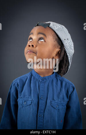 Handsome boy doing different expressions in different sets of clothes: thinking Stock Photo