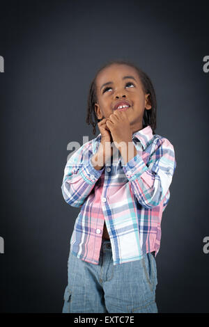 Handsome boy doing different expressions in different sets of clothes: thinking Stock Photo