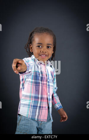 Handsome boy doing different expressions in different sets of clothes: pointing Stock Photo