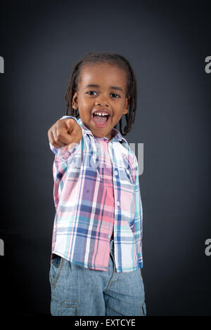 Handsome boy doing different expressions in different sets of clothes: pointing Stock Photo