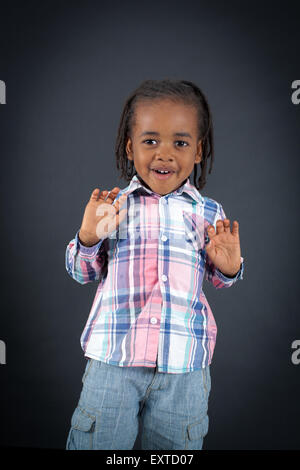 Handsome boy doing different expressions in different sets of clothes: innocent Stock Photo