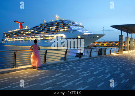Woman admiring cruise ship from  Bahia Urbana (Urban Bay), Old San Juan, Puerto Rico