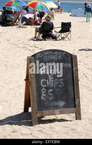 St Ives, Cornwall, UK: Chalkboard sign on Porthminster beach advertising takeaway Fish & Chips. Stock Photo