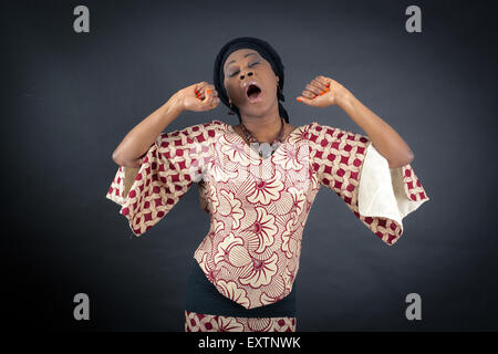Beautiful woman doing different expressions in different sets of clothes: wake up Stock Photo