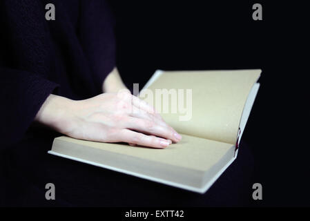 female hands on a closed book Stock Photo