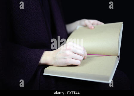 female hands holding an open book Stock Photo