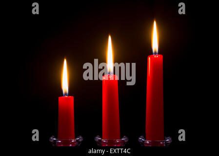 Three red candles on a black background Stock Photo