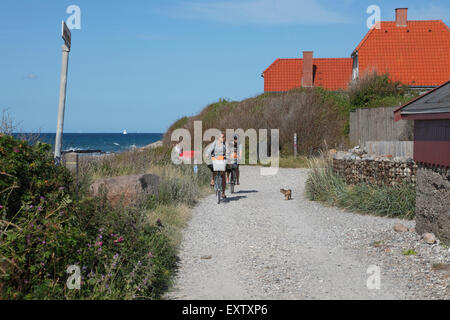 A path along the rough Kattegat coast in Kikhavn, a fishing hamlet with a warm and cosy atmosphere 2 km east of Hundested. Cyclers or cyclists. Stock Photo