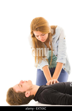 Couple demonstrating first aid techniques with woman applying cpr on male pattient lying down Stock Photo