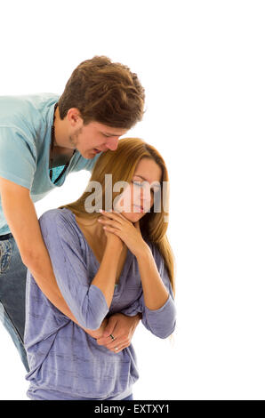 Couple demonstrating first aid techniques by performing heimlich on choking woman from behind Stock Photo
