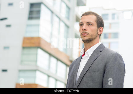 Man formal clothing in urban environment looking forward concentrated shot from front side angle Stock Photo