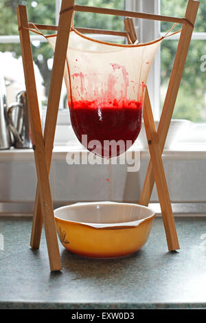 Jam Making - straining fruit through muslin bag to remove seeds ad skins  Stock Photo - Alamy