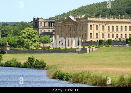 Chatsworth House seen from the banks of the River Derwent on a glorious summer day, Peak District, Derbyshire UK Stock Photo