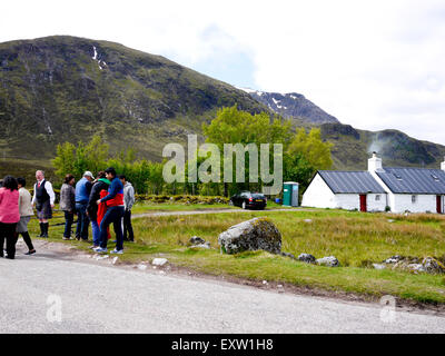 Black Rock Cottage with visitors taking photographs , Rannoch Moor,Argyle,Scotland, UK. Stock Photo