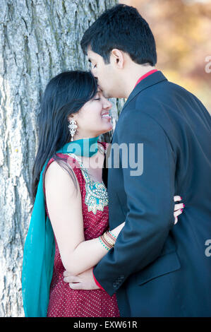 Young Happy Indian Man Kissing His Bride On The Forehead Stock Photo