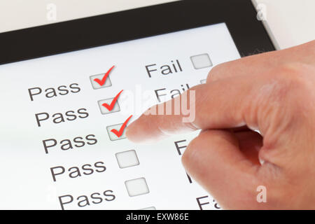 Completing the form on a digital tablet Stock Photo