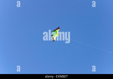 Beautiful kite flying in a blue summers sky, England, UK Stock Photo