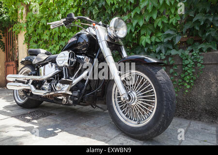 Ajaccio, France - July 6, 2015:  Black Harley Davidson motorcycle with chromed details stands parked Stock Photo