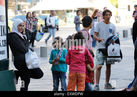 Athens, GREECE. 17th July, 2015. Migrants are arriving at the port of Piraeus, Greece, on a nearly daily basis. On Thursday morning, another 200 Syrian migrants and refugees traveled from Greek islands' detention centers to Piraeus and later moved to Omonoia Square in downtown Athens. Most of them are forced to sleep on the hard floor, while many mothers are struggling to find food for their children. Credit:  ZUMA Press, Inc./Alamy Live News Stock Photo