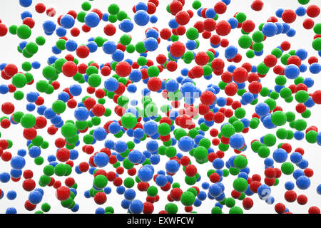 Small red green and blue balls floating on a white background. A 3D rendering. Stock Photo