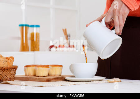 Young woman making coffee for breakfast, Stock Photo