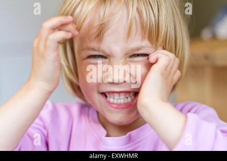 Girl pulling faces Stock Photo
