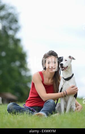 Woman with a mongrel dog on a meadow, Bavaria, Germany, Europe Stock Photo