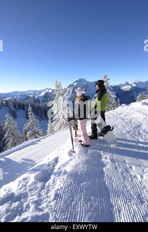Female skier and snowboarder, Tegelberg, Ammergau Alps, Allgaeu, Bavaria, Germany, Europe Stock Photo