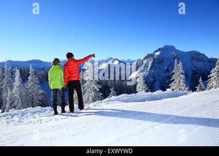 Two women in snow, Tegelberg, Ammergau Alps, Allgaeu, Bavaria, Germany, Europe Stock Photo