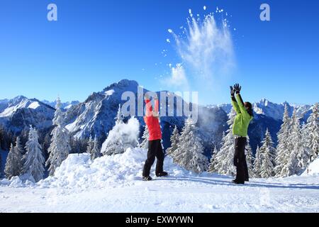 Two persons in snow, Tegelberg, Ammergau Alps, Allgaeu, Bavaria, Germany, Europe Stock Photo