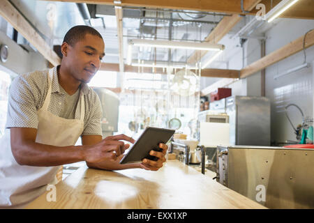 Bakery owner using digital tablet Stock Photo