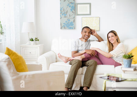 Mid adult couple relaxing in living room Stock Photo