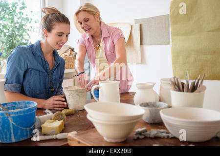 Two women making pottery in studio Stock Photo