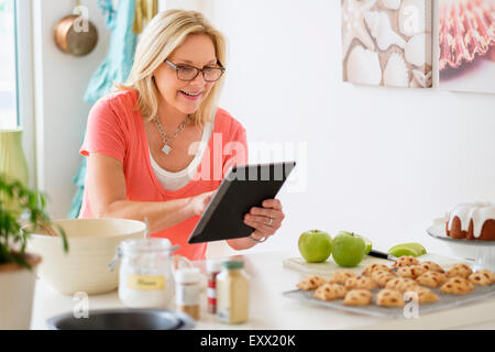 Mature woman baking in kitchen Stock Photo