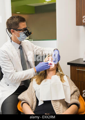 Dentist and patient in dentist's office Stock Photo