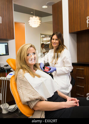 Dentists and patient in dentist's office Stock Photo