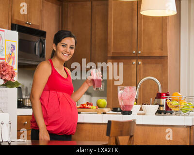 Portrait of pregnant woman with fruit cocktail Stock Photo
