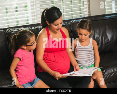 Mother reading to children (6-7, 8-9) Stock Photo