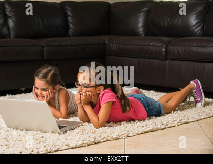 Girls (6-7, 8-9) using laptop at home Stock Photo