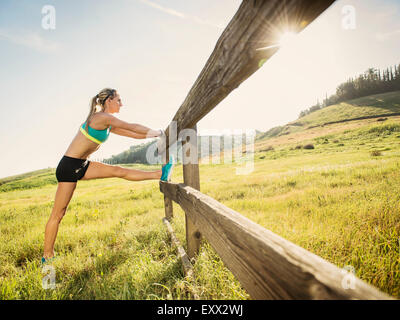 Woman stretching outdoors Stock Photo