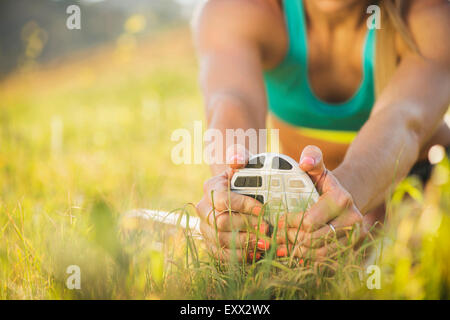 Woman exercising in field Stock Photo