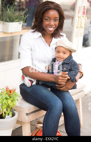 Portrait of smiling woman holding son (12-17 months) Stock Photo
