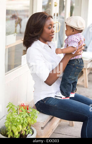 Portrait of smiling woman holding son (12-17 months) Stock Photo