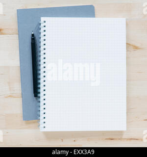 Overhead view of pen on notebook Stock Photo