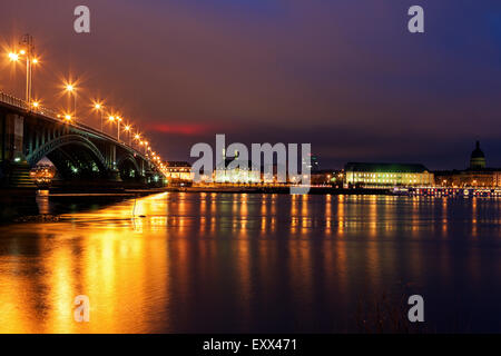 Illuminated Theodor Heuss Bridge and waterfront skyline Stock Photo
