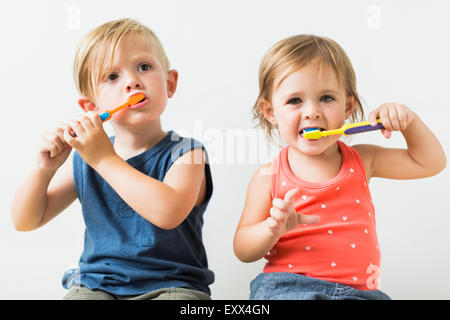 Children (2-3) brushing teeth Stock Photo