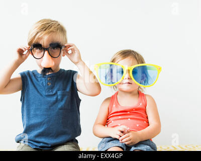 Children (2-3) wearing novelty glasses Stock Photo